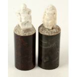 A pair of Cornish serpentine cylindrical columns, each surmounted by a parian figure, height 15.5cm.