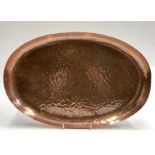 A Newlyn copper oval tray, with planished finish, stamped 'Newlyn', 42 x 28cm.