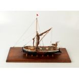 A scratch built model of a Thames barge, height 33cm, size of plinth 16.3 x 46cm.