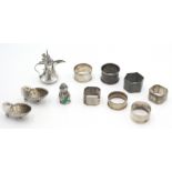 A pair of silver shell salts, a miniature silver Arabic coffee pot, six various silver napkin rings,