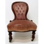 A Victorian mahogany lady's salon chair, with a padded back and seat on turned tapering legs,