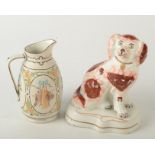 A Victorian Staffordshire spaniel and a Victorian moulded smear glazed porcelaneous jug.