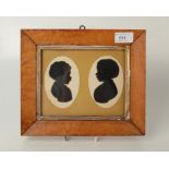 Two silhouette portraits of young girls, in a maple frame, 22 x 25.7cm.