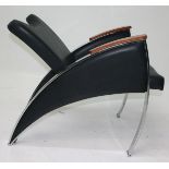 A 1970s chrome and black leather armchair, with wooden arm rests, height 74cm, depth 90cm,