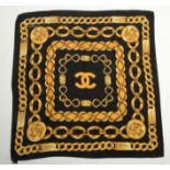 A Chanel silk scarf, black with gold chain link design, 85cm x 85cm.