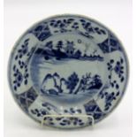 A Chinese blue and white porcelain dish, 18th century, decorated with a river scene, diameter 22.