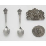 An army nurse brooch, a part silver buckle and two Rolex spoons.