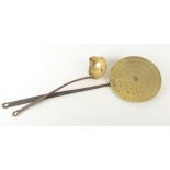 An 18th century brass cream skimmer, with iron handle, length 65cm, diameter 21cm and a brass ladle.