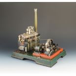 A Marklin for Gamages tinplate static steam engine generator with single horizontal cylinder,