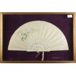 A silkwork fan, 1920s, with floral painted decoration and pierced ivory sticks, in a display frame,