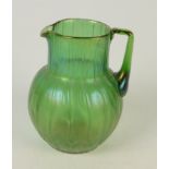 An iridescent Loetz style green glass jug, with overall moulded decoration, height 16cm.