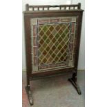 An early 20th century stained mahogany lead lined and stained glass fire screen, height 106cm,