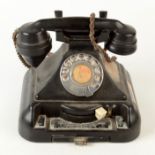 A black bakelite telephone, with pull out tray and extension lever, height 19cm, width 23cm.