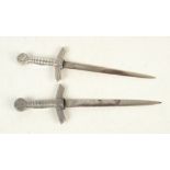 A pair of German metal letter knives, in the form of daggers, length 20.5cm.