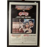 A cinema poster advertising Grease and Saturday Night Fever, framed and glazed,