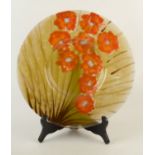 An art glass shallow charger with nine orange flower heads, diameter 43cm.