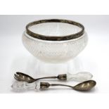 A cut glass punch bowl with silver rim,