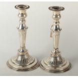 A pair of electro plated silver on copper candlesticks with bats wing fluting and beaded borders.