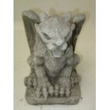 A reconstitued stone finial, cast as a fantastic winged beast on a square base, height 34cm.