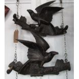 A pair of Black Forest carved wood coat hooks, each surmounted by a bird, 23 x 31cm.