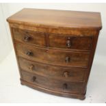 A Victorian mahogany bow front chest of drawers, with two short and three long drawers on bun feet,