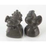 Two South East Asian bronze scroll weights, heights 5.5cm and 5.3cm.