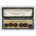 A set of six 19th century spherical Cornish serpentine buttons, cased.