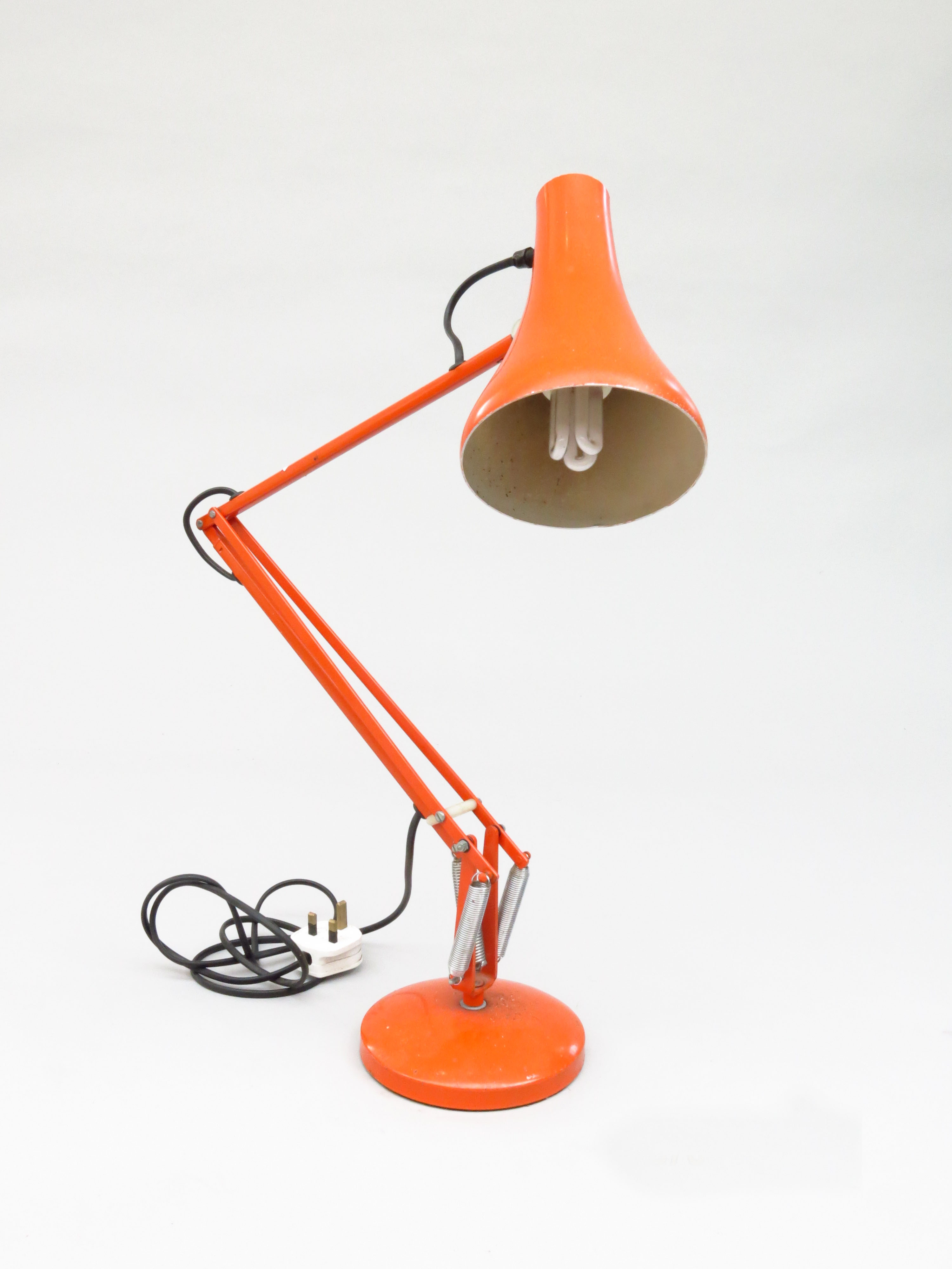 An orange Anglepoise lamp, extended height 85cm.