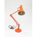 An orange Anglepoise lamp, extended height 85cm.