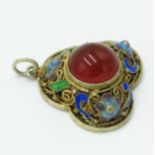 A Chinese silver gilt filigree trefoil pendant with central carnelian surrounded by scroll work and