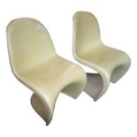 Two Verner Panton white plastic chairs, height 83cm, width 49cm, depth 53cm.