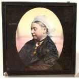 A coloured magic lantern slide of Queen Victoria, 8cm square.