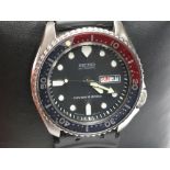 A Seiko automatic diver's watch with Pepsi dial.