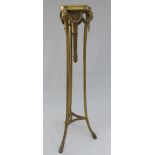 An Adams style gilt torchere, late 19th century, the circular top above rams masks and swags,