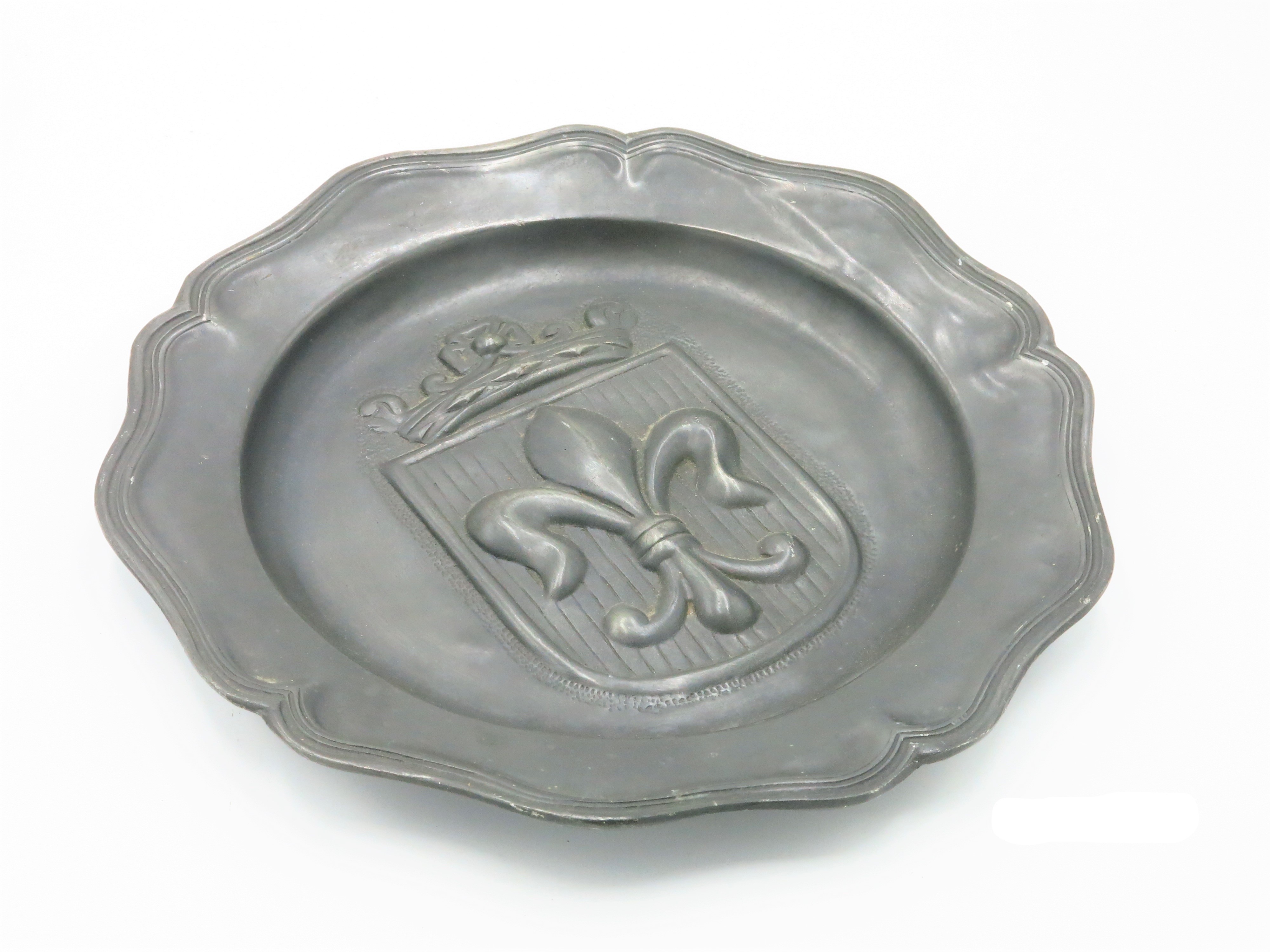 A continental pewter plaque, early 20th century, deeply impressed with a crowned fleur de lis,