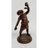 A bronze figure of Bacchus, holding a snake, wearing a loin cloth on a circular base, height 54cm.