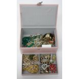 Costume jewellery in a pink case.