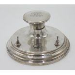 A silver capstan inkwell.