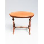A Victorian mahogany centre table, with an oval top, on turned columns and downswept legs,
