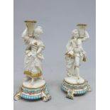 A pair of Victorian porcelain figural candlesticks, perhaps Minton,