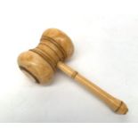 A Victorian turned ivory gavel, height 6cm, length 13cm.