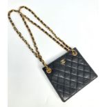 A Chanel black lambskin leather quilted evening bag, with chain and leather shoulder straps,