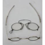 A pair of George lV silver reading glasses with extending sliding arms,