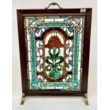 A firescreen, with inset rectangular leaded glass panel, height 71cm, width 53cm.