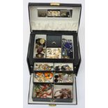 Costume jewellery in a black jewel case.