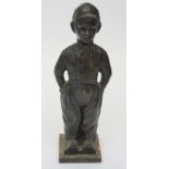 A cast iron Fireside companion set, modelled as a Dutch boy, in clogs, lacking fire tools,