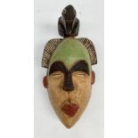 An African wooden Ogoni tribal polychrome mask, Nigeria, height 38cm width 19.5cm.