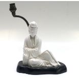 A Chinese blanc de chine porcelain figural lamp, on a wooden plinth, height of figure 19.5cm.