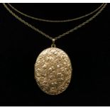 An engraved large oval 9ct gold locket on gold chain together with one other gold chain, 11g.