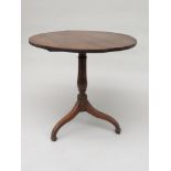 A George III oak tripod table, the circular top on a baluster stem and downswept legs, height 71cm,